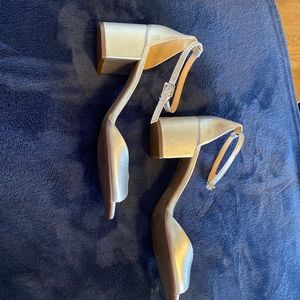 Beautiful, silver leather shoes,9B, brand new. Small scratch on right shoe.